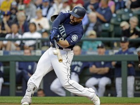 FILE - In this Aug. 14, 2017, file photo, Seattle Mariners' Yonder Alonso doubles against the Baltimore Orioles in the first inning of a baseball game in Seattle. A person familiar with the negotiations says free-agent first baseman Yonder Alonso and the Cleveland Indians have agreed to contract terms. Alonso's deal is contingent on him passing a physical, according to a person who spoke to The Associated Press on condition of anonymity Thursday because the agreement had not been announced.