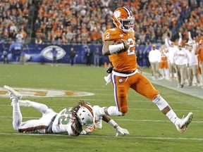 FILE - In this Dec. 2, 2017, file photo, Clemson's Kelly Bryant (2) runs past Miami's Sheldrick Redwine (22) for a touchdown during the first half of the Atlantic Coast Conference championship NCAA college football game in Charlotte, N.C.Bryant answered the question of how the Tigers would fare in life without Deshaun Watson. Bryant is completing 67.4 percent of his passes and has also run for 11 touchdowns.