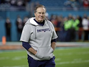 FILE - In this Dec. 11, 2017, file photo, New England Patriots coach Bill Belichick watches his team warm up before an NFL football game against the Miami Dolphins in Miami Gardens, Fla. With five Super Bowl titles and the third most wins in NFL history, the comparisons for Bill Belichick are with the all-time greats in the game rather than his current peers.