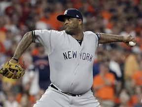 File- This Oct. 21, 2017, file photo shows New York Yankees starting pitcher CC Sabathia throwing during the first inning of Game 7 of baseball's American League Championship Series in Houston. Sabathia's $10 million, one-year contract has been finalized by the Yankees, a deal that raises New York's projected luxury tax payroll for next year to about $178 million. The deal was announced Tuesday, Dec. 26, 2017, about 10 days after the sides reached an agreement pending a physical.