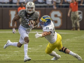 FILE - In this Sept. 9, 2017, file photo, Virginia Tech's Greg Stroman (3) breaks away for a touchdown on a punt return against Delaware's Christian Lohin (94) during the first half of an NCAA college football game in Blacksburg, Va. Stroman was selected to the AP All-Conference ACC team announced Tuesday, Dec. 5, 2017.