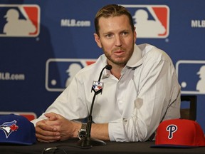 FILE - In this Dec. 9, 2013, file photo, two-time Cy Young Award winner Roy Halladay answers questions after announcing his retirement after 16 seasons in the major leagues with Toronto and Philadelphia at the Major League Baseball winter meetings in Lake Buena Vista, Fla. Halladay died in 2017, at age 40.