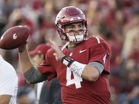 FILE - In this Sept. 2, 2017, file photo, Washington State quarterback Luke Falk warms up for an NCAA college football game against Montana State in Pullman, Wash. Falk won the Burlsworth Award, Monday, Dec. 4, 2017, given annually to the top college football player who began his career as a walk-on.