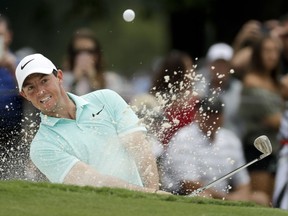 FILE - In this Aug. 9, 2017, file photo, Rory McIlroy of Northern Ireland, hits from the bunker on the ninth hole during a practice round at the PGA Championship golf tournament at the Quail Hollow Club, in Charlotte, N.C. McIlroy plans to play at least seven tournaments leading into the Masters next year.