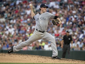 FILE - In this July 17, 2017, file photo, New York Yankees starting pitcher Bryan Mitchell throws to the Minnesota Twins in the third inning of a baseball game, in Minneapolis. Third baseman Chase Headley and pitcher Bryan Mitchell have been traded by the Yankees to the San Diego Padres, Tuesday, Dec. 12, 2017, giving New York added payroll flexibility and room for infield prospects.