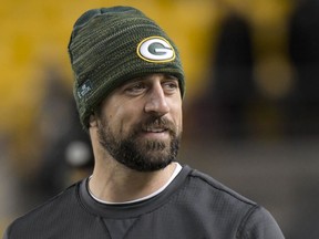 FILE - In this Sunday, Nov. 26, 2017, file photo, Green Bay Packers injured quarterback Aaron Rodgers watches warm ups before an NFL football game against the Pittsburgh Steelers in Pittsburgh. Rodgers is expected to return to practice on Saturday. The two-time MVP was placed on injured reserve six weeks ago after breaking his right collarbone in an Oct. 15 game against Minnesota. The