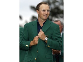 FILE - In this April 21, 2015, file photo, Jordan Spieth wears his green jacket after winning the Masters golf tournament in Augusta, Ga. Spieth says the jacket is too big for him because he still has the one given to him the day he won the Masters.