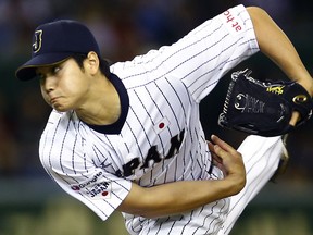 FILE - In this Nov. 19, 2015, file photo, Japan's starter Shohei Otani pitches against South Korea during the first inning of their semifinal game at the Premier12 world baseball tournament at Tokyo Dome in Tokyo. A person familiar with the decision says Major League Baseball owners on Friday, Dec. 1, 2017, have approved a new posting agreement with their Japanese counterparts in a move that allows bidding to start for coveted pitcher and outfielder Shohei Ohtani.   The person spoke on condition of anonymity because no announcement had been made. (AP Photo/Shizuo Kambayashi, File)