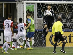 FILE - In this July 19, 2017, file photo, Seattle Sounders goalkeeper Tyler Miller second from right, leaps to grab the ball against D.C. United in the second half of an MLS soccer match, in Seattle. Seattle goalkeeper Tyler Miller is the Los Angeles Football Club's first pick in the Major League Soccer expansion draft, Tuesday, Dec. 12, 2017.