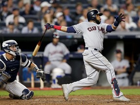 FILE - In this Oct. 9, 2017, file photo, Cleveland Indians' Carlos Santana connects for a two-run home run against the New York Yankees during the fourth inning in Game 4 of baseball's American League Division Series, in New York. Two people familiar with the situation say the Phillies and veteran first baseman Carlos Santana have agreed to a three-year, $60 million deal. The people spoke Friday, Dec. 15, 2017, on condition of anonymity because the agreement is contingent on Santana passing a physical. The 31-year-old Santana hit 23 home runs and had 79 RBIs with Cleveland last season, where he had spent all eight years of his career.