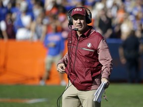 FILE - In this Nov. 25, 2017, file photo, Florida State head coach Jimbo Fisher watches during the second half of an NCAA college football game against Florida in Gainesville, Fla. Two people with direct knowledge of the decision say Fisher has resigned to take the same job at Texas A&M. Fisher handed in his resignation after a meeting with university President John Thrasher on Friday, Dec. 1, 2017. according to the people who spoke on condition of anonymity because Florida State had not announced the move. (AP Photo/John Raoux, File)
