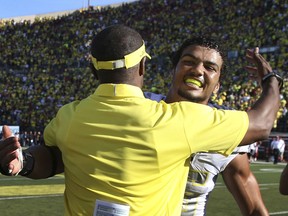 FILE - In this Sept. 9, 2017, file photo, Oregon head coach Willie Taggart and linebacker Troy Dye, rear, embrace after defeating Nebraska, 42-35, in an NCAA college football game, in Eugene, Ore. Dye was selected to the AP All-Conference Pac-12 team announced Thursday, Dec. 7, 2017.