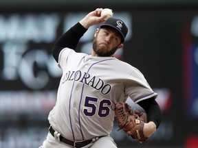 FILE - In this May 18, 2017, file photo, Colorado Rockies pitcher Greg Holland throws against the Minnesota Twins in the ninth inning of the first baseball game of a doubleheader in Minneapolis. Holland has been voted NL Comeback Player of the Year on Friday, Dec. 1, 2017. After missing the 2016 season while recovering from Tommy John surgery, Holland was 3-2 with a 3.61 ERA and 41 saves.  (AP Photo/Jim Mone, File)