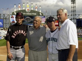 In this  July 15, 2003  file photo, then-Cincinnati Reds' Aaron Boone, left, and his brother, Bret, second from right, pose with their grandfather, Ray, second from left, and father, Bob, right, before the 74th Major League Baseball All-Star Game at U.S. Cellular Field in Chicago. Aaron Boone's hiring has been finalized by the New York Yankees, who gave the ESPN broadcaster a three-year contract to succeed Joe Girardi as manager, Monday, Dec. 4, 2017. New York said he will be introduced Wednesday at Yankee Stadium.