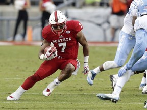 File- This Nov. 25, 2017, file photo shows North Carolina State's Nyheim Hines (7) running against North Carolina during the first half of an NCAA college football game in Raleigh, N.C. The Wolfpack (8-4) is seeking the second-most wins in school history, and trying to stay in the final College Football Playoff rankings. N.C. State was No. 24 going into bowl season. "This year it's really important to have a Top 25 finish,"  Hines said. "We haven't done that yet since I've been here."