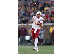 File- This Nov. 11, 2017, file photo shows Nebraska quarterback Tanner Lee (13) passing the ball against Minnesota during the first quarter of an NCAA college football game on , in Minneapolis. Lee is forfeiting his final year of eligibility and will enter the NFL draft. Lee tweeted Thursday, Dec. 28, 2017, "after weeks of prayer and consideration with my family, I've decided to enter the NFL draft and pursue an opportunity that I feel is the best for myself and my family at this time."