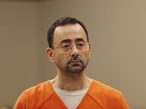 FILE - In this Nov. 22, 2017, file photo, Dr. Larry Nassar, appears in court for a plea hearing in Lansing, Mich. Nassar, an elite Michigan sports doctor who possessed child pornography and assaulted gymnasts, was sentenced Thursday, Dec. 7, 2017,  to 60 years in federal prison in one of three criminal cases that ensure he will never be free again.