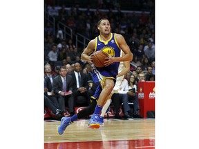 FILE - In this Oct. 30, 2017, file photo, Golden State Warriors guard Klay Thompson goes to the basket during the second half of an NBA basketball game against the Los Angeles Clippers in Los Angeles. Members of the defending NBA champion Warriors jumped in to help after wildfires scorched the West Coast in October. Thompson donated $75,000 to fire relief efforts by giving $1,000 for each point he scored during a three-game stretch. The Oakland Raiders organization gave $1 million and the Raiders, Warriors and 49ers combined on a donation of $450,000.