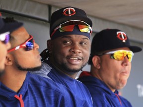 File-This Aug. 6, 2017, file photo shows Minnesota Twins third baseman Miguel Sano sitting in the dugout against the Texas Rangers in the sixth inning during a baseball game on  in Minneapolis.  A photographer is accusing  Sano of grabbing her wrist and trying to kiss her and pull her through a door after a 2015 autograph session. Betsy Bissen accused Sano on Thursday, Dec. 28, 2017, in a tweet, saying what he did amounted to assault.