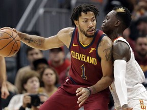 FILE - In this Nov. 5, 2017, file photo, Cleveland Cavaliers' Derrick Rose, left, drive against Atlanta Hawks' Dennis Schroder (17), from Germany, in the first half of an NBA basketball game in Cleveland.Cavaliers guard Derick Rose revealed he has a bone spur in his left ankle contributed to him leaving the team. Rose left the Cavs on Nov. 22 and only returned this week, Friday, Dec. 8, 2017.