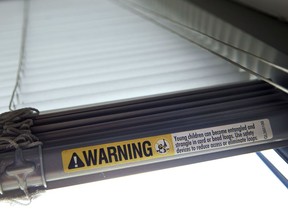 FILE - This Wednesday, May 6, 2015 file photo shows a warning label of strangulation risks from mini blind cords in Washington. According to a study released on Monday, Dec. 11, 2017, children's injuries and deaths from window blinds have not stalled despite decades of safety concerns.