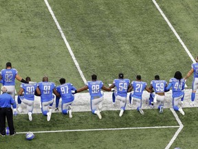 FILE - In this Sept. 24, 2017, file photo, Detroit Lions players take a knee during the national anthem before an NFL football game against the Atlanta Falcons in Detroit. President Donald Trump's feud with the NFL about players kneeling during the national anthem is the runaway winner for the top sports story of 2017 in balloting by AP members and editors.