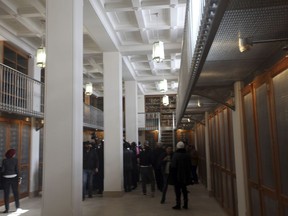 Officials walk around the main hall of the newly opened Saint Cathrine Ancient Library in South Sinai, Egypt on Saturday, Dec. 16, 2017. The inauguration ceremony, attended by Egyptian and western officials, comes after three years of restoration work on the eastern side of the library that houses the world's second largest collection of early codices and manuscripts, outnumbered only by the Vatican Library, according to Monk Damyanos, the monastery's archbishop.