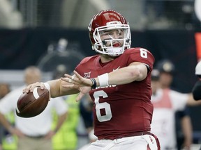 FILE - In this Dec. 2, 2017, file photo, Oklahoma quarterback Baker Mayfield (6) throws a pass in the first half of the Big 12 Conference championship NCAA college football game against TCU  in Arlington, Texas. Mayfield, reigning Heisman winner Lamar Jackson of Louisville and Stanford running back Bryce Love were chosen as finalists for the Heisman Trophy on Monday, Dec. 4, 2017.