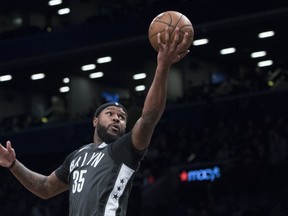 FILE - In this Dec. 2, 2017, file photo, Brooklyn Nets forward Trevor Booker (35) goes to the basket during the first half of an NBA basketball game against the Atlanta Hawks in New York. A person familiar with the deal says the Philadelphia 76ers are set to trade beleaguered center Jahlil Okafor to the Nets along with guard Nik Stauskas and a 2019 second-round draft pick for forward Booker.