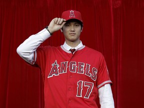 FILE - In this Dec. 9, 2017, file photo, Baseball player Shohei Ohtani, of Japan, poses for photos after a news conference at Angel Stadium, in Anaheim, Calif. Los Angeles Angels-bound Ohtani bid farewell to fans of his former Japanese club on Monday, Dec. 25, as he sets off to join his new team.