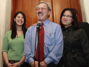 FILE - In this Nov. 9, 2011, file photo,San Francisco Mayor Ed Lee, center, speaks at a news conference next to his wife Anita, right, and his daughter Brianna, left, outside of his office at City Hall in San Francisco. The San Francisco Chronicle reported that Lee died early Tuesday, Dec. 12, 2017. He was 65.