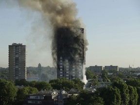 FILE- In this June 14, 2017, file photo, smoke rises from a high-rise apartment building on fire in London. Six months after flames enveloped the high-rise in London and prompted concerns about the safety of other buildings worldwide, a U.S.-based fire prevention group has developed a tool aimed at making buildings safer. The National Association of State Fire Marshals' research foundation announced that its free risk evaluation tool will be available on its website after Jan. 1, 2018.