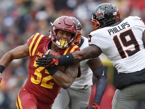 FILE - In this Nov. 11, 2017, file photo, Iowa State running back David Montgomery (32) breaks a tackle by Oklahoma State linebacker Justin Phillips (19) during the first half of an NCAA college football game, in Ames, Iowa. Memphis plays Iowa State in the Liberty Bowl on Saturday, Dec. 30.