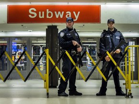 Police stand guard inside the Port Authority Bus Terminal following an explosion near Times Square on Monday, Dec. 11, 2017, in New York. Police said a man with a pipe bomb strapped to his body set off the crude device in a passageway under 42nd Street between Seventh and Eighth Avenues.