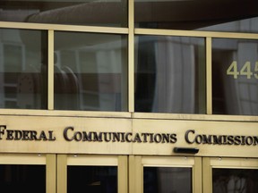 FILE - This June 19, 2015, file photo, shows the entrance to the Federal Communications Commission (FCC) building in Washington. In its push to undo Obama-era "net neutrality" rules, the country's Republican-led telecom regulator has defended its proposal with some statements that are incomplete or misleading. But a Democratic official in favor of net neutrality also criticized the Federal Communications Commission Chairman, Ajit Pai, in a way that left out crucial context.