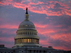 FILE - In this Thursday, Nov. 30, 2017, file photo, the sky over The Capitol is lit up at dawn as Senate Republicans work to pass their sweeping tax bill, in Washington. Congress' last major tax overhaul, three decades ago, was everything this year's version isn't. The Tax Reform Act of 1986 won bipartisan support. Its benefits flowed more to low- and middle-income taxpayers than to wealthy individuals and corporations. And it added nothing to the federal deficit. None of that can be said for tax-cut package the Senate passed after the House approved a similar version.