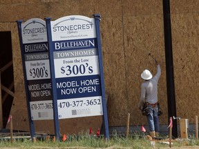 FILE - In this Tuesday, May 16, 2017, file photo, a construction worker continues work on new town homes under construction in Woodstock, Ga. The Standard & Poor's CoreLogic Case-Shiller home price index, which tracks the value of homes in 20 major U.S. metropolitan areas, is due out Tuesday, Dec. 26, 2017.