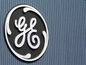 FILE - This June 24, 2014, file photo, shows the General Electric logo at a plant in Belfort, France. On Thursday, Dec. 7, 2017, GE said it will cut 12,000 jobs in its power division as alternative energy supplants demand for coal and other fossil fuels.