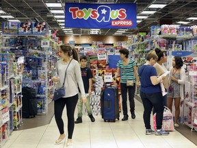 FILE - In this Friday, Nov. 25, 2016, file photo, shoppers browse at a Toys R Us store in Miami. The toys your kids unwrap this Christmas could invite hackers into your home. That Grinch-like warning comes from the FBI, which said this summer that toys connected to the internet could be a target for crooks who may listen in on conversations or use them to steal a child's personal information.