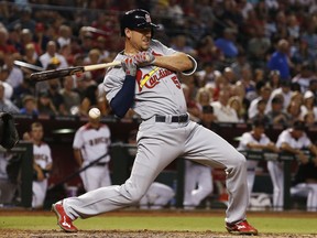 FILE - In this June 28, 2017 photo, St. Louis Cardinals' Stephen Piscotty gets hit with a pitch against the Arizona Diamondbacks during the fourth inning of a baseball game  in Phoenix. Piscotty was traded by the St. Louis Cardinals to the Oakland Athletics for a pair of infield prospects, allowing the outfielder to be near his family's home in Pleasanton, California, following his mother's diagnosis with Lou Gehrig's disease.