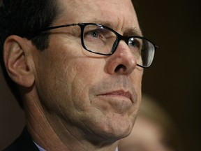 FILE - In this Dec. 7, 2016 file photo, AT&T Chairman and CEO Randall Stephenson listens on Capitol Hill in Washington, while testifying before a Senate Judiciary subcommittee hearing on the proposed merger between AT&T and Time Warner. After an exchange between AT&T's CEO and a union representing its workers, the company says it took steps to pay workers a $1,000 bonus in response to President Donald Trump's tax cuts. The Communications Workers of America had pushed AT&T last month to guarantee workers would receive the $4,000 raise that White House economists said would be the result of the corporate tax cuts.
