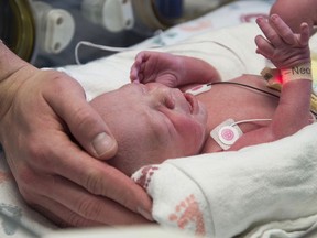 In this undated photo provided by Baylor University Medical Center the first baby born as a result of a womb transplant in the United States lies in the neonatal unit at Baylor University Medical Center in Dallas. (Baylor University Medical Center via AP)