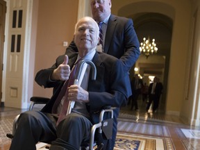 FILE - In this Dec. 1, 2017 file photo, Sen. John McCain, R-Ariz., leaves a closed-door session where Republican senators met on the GOP effort to overhaul the tax code, on Capitol Hill in Washington. President Donald Trump says McCain is returning home to Arizona after being hospitalized over the side effects from his brain cancer treatment. The 81-year-old McCain has been hospitalized at Walter Reed Medical Center in Maryland.