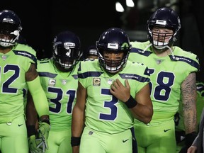 FILE - In this Nov. 9, 2017, file photo, Seattle Seahawks quarterback Russell Wilson (3) during an NFL football game against the Arizona Cardinals in Glendale, Ariz. The Seahawks have been fined $100,000 for not properly following concussion protocol with Wilson during a game in November. The NFL and NFLPA announced their decision Thursday, Dec. 21, 2017, following an investigation that lasted more than a month.