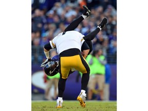 FILE - In this Nov. 6, 2016, file photo, Baltimore Ravens cornerback Jerraud Powers sacks Pittsburgh Steelers quarterback Ben Roethlisberger in the second half of an NFL football game in Baltimore. "When you play Baltimore you are going to get your head knocked off, they're going to knock your head off, you're going to try to knock theirs off, but you're going to help them up and respect it, and say 'Hey great job, let's go at it again," Roethlisberger says. The two teams meet on Sunday.