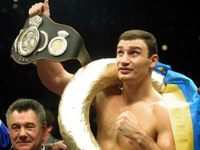 FILE - In this Jan. 28, 2001, file photo, Vitali Klitschko, of Ukraine, shows the world championship belt. after he knocked out Orlin Norris, of the United States, in the first round of a WBO heavyweight title fight in Munich, Germany. Former heavyweight champion Vitali Klitschko, four-division world champion Erik Morales, and light middleweight champion Ronald Wright have been elected to the International Boxing Hall of Fame on Tuesday, Dec. 5, 2017. The Induction ceremony is June 10, 2018, in Canastota, N.Y.