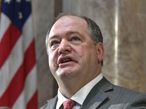 FILE - In this Jan. 3, 2017 file photo, Jeff Hoover looks up to the cheers from the gallery following his swearing in Frankfort, Ky. Hoover, the former House Speaker, denied sexual harassment but said he did send inappropriate but consensual text messages. It's unclear what the other three Republican lawmakers involved in the settlement are accused of doing.