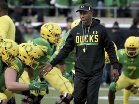 FILE - In this Nov. 18, 2017, file photo, Oregon head coach Willie Taggart, center, greets his players during warmups before an NCAA college football game against Arizona in Eugene, Ore. A person with direct knowledge of the situation says Willie Taggart has agreed to become Florida State's next football coach.  The person says Taggart has called a team meeting to inform his Oregon players he is heading to Tallahassee to replace Jimbo Fisher. Florida State. The person spoke to The Associated Press Tuesday, Dec. 5, 2017, on condition of anonymity because neither school had announced the move.