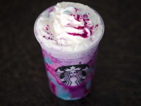 FILE - In this April 20, 2017, file photo, a Starbucks Unicorn Frappuccino is displayed in Philadelphia.  It "magically" started as a purple drink with swirls of blue and a first taste that is sweet and fruity, according to the company.