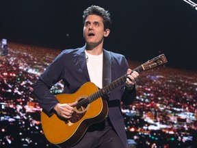 FILe - In this April 7, 2017 file photo, John Mayer performs in concert during his "The Search for Everything Tour" in Philadelphia. Mayer has been hospitalized for an emergency appendectomy. The Grammy-winning musician was admitted to the hospital on Tuesday, Dec. 5, according to a rep. The singer-guitarist was due to perform later that night at a concert with the Dead & Company, but that date has now been postponed.